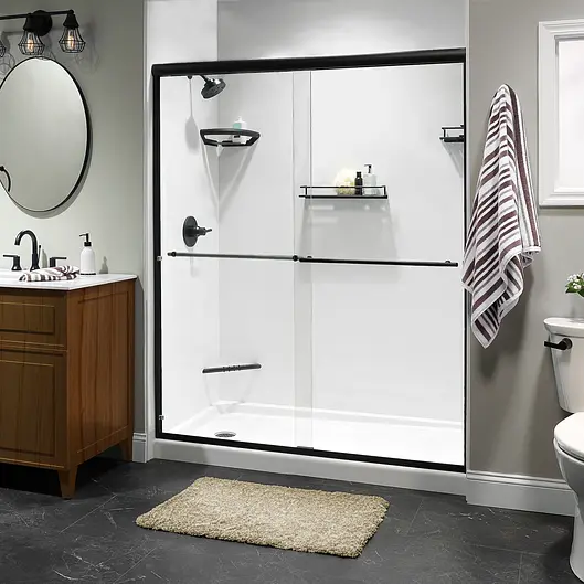 Newly installed glass sliding shower with black hardware